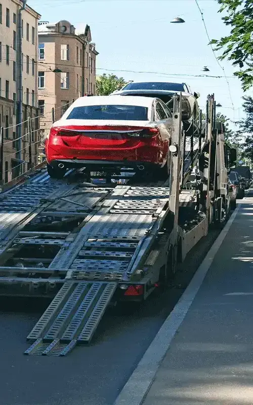 Car being loaded onto flatbed truck for transportation.